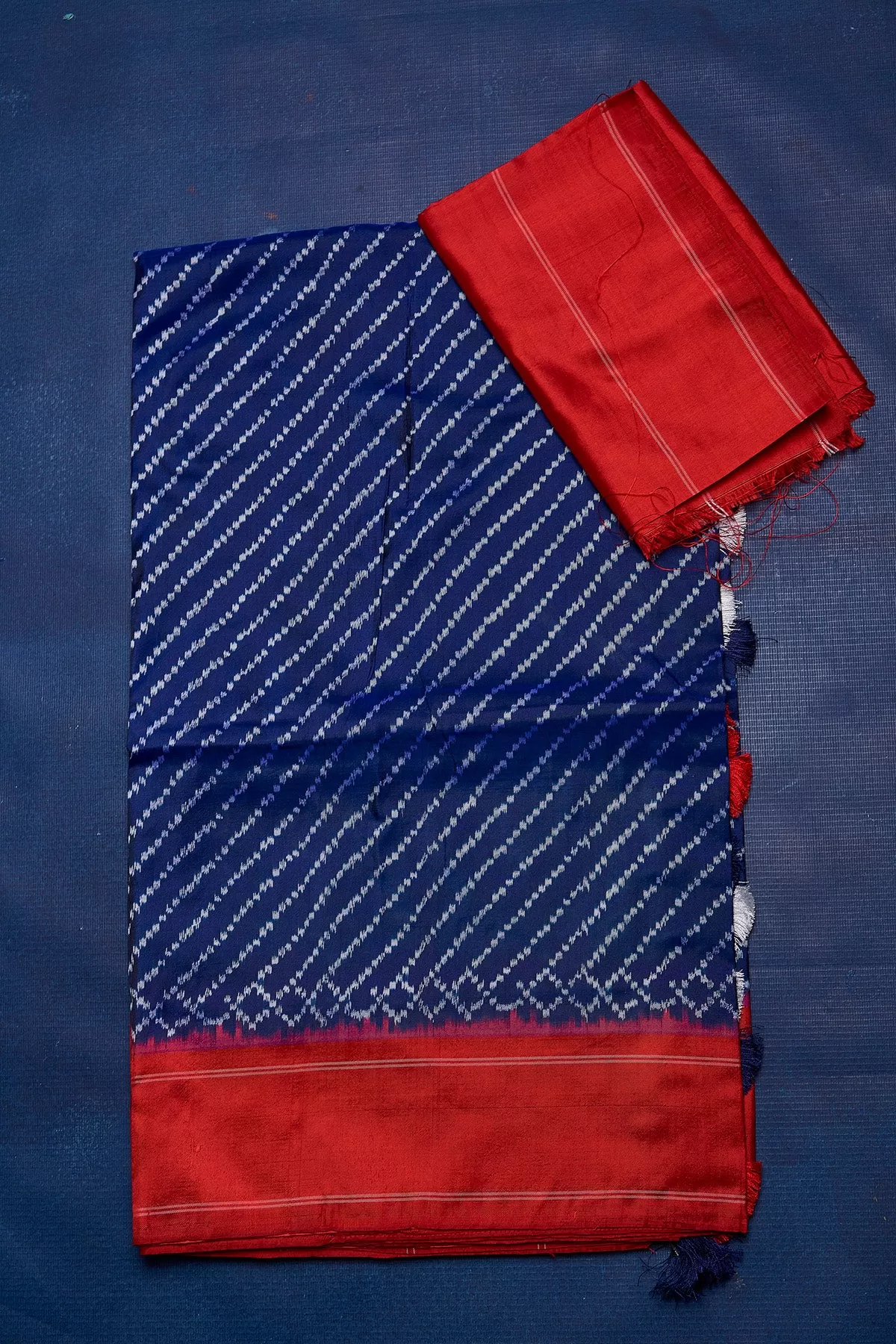 90M220 Royal Blue Ikkat Silk Saree with Red Border